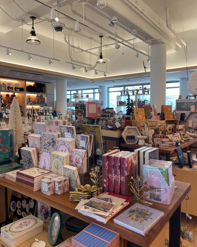 Various books and notebooks on a display table inside Myriad Gardens Gift Shop.